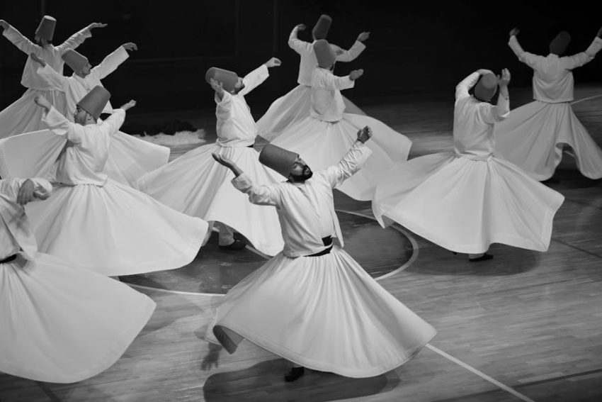 A whirling dervish in mid-rotation, symbolizing the soul's ecstatic dance toward divine union.