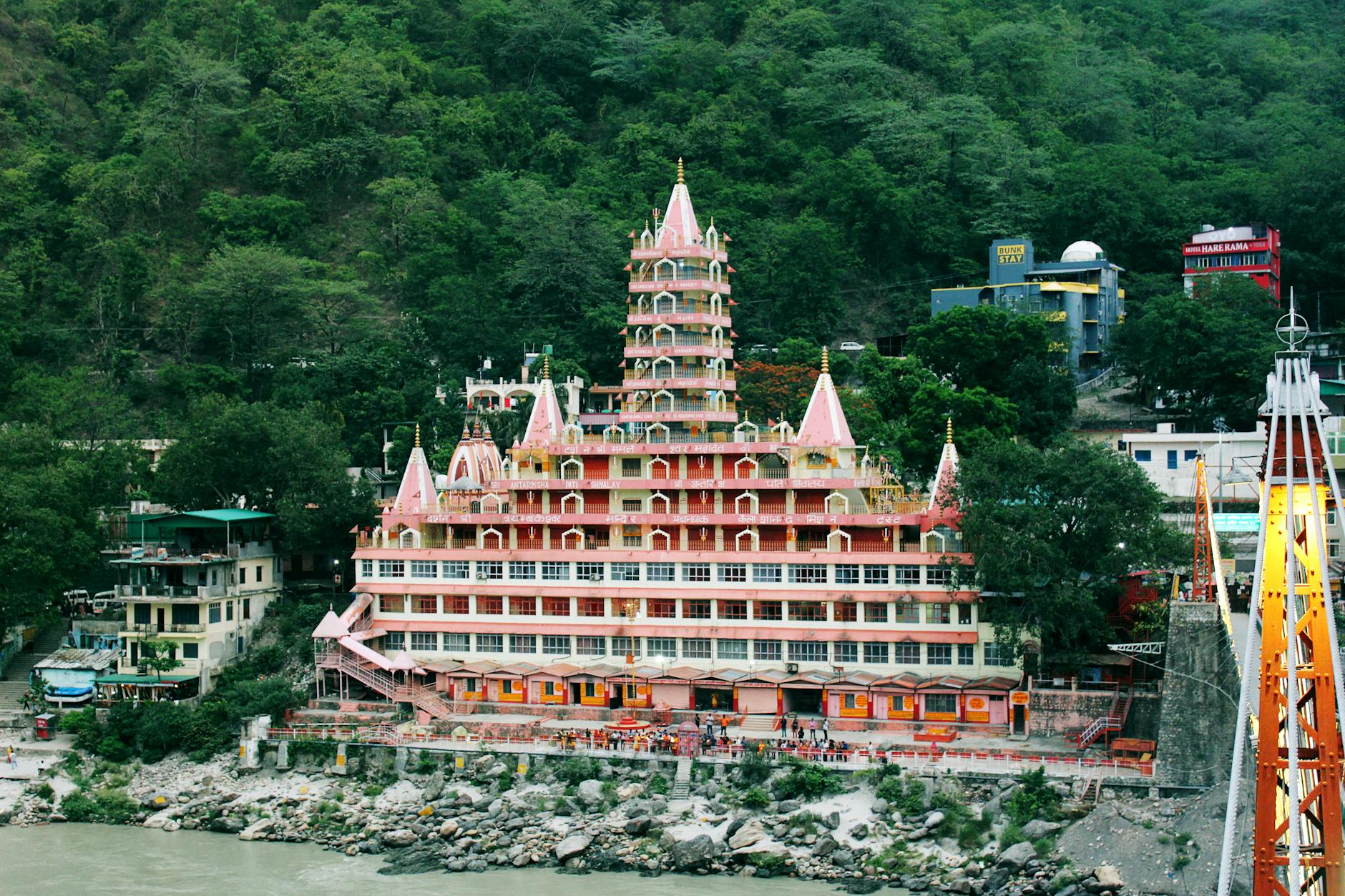Stunning view of Tera Manzil Temple against lush hills in Rishikesh, India.