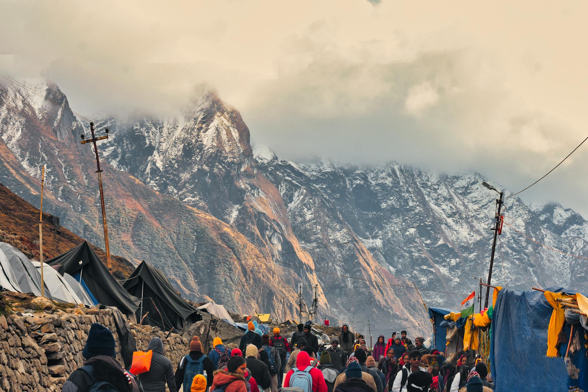 Check out the lively streets of Kedarnath with stunning Himalayan backdrop, capturing the essence of local life.