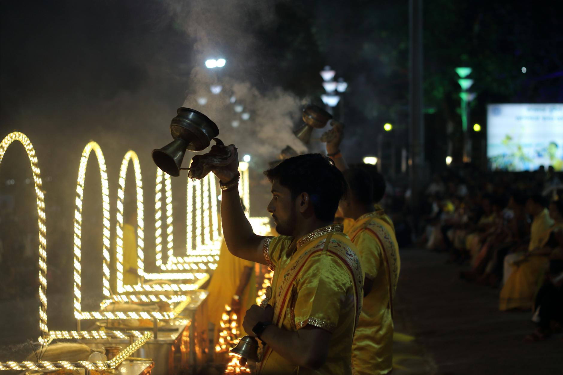 A vivid evening Ganga Aarti ceremony with devotees practicing traditional fire rituals along the riverbank.