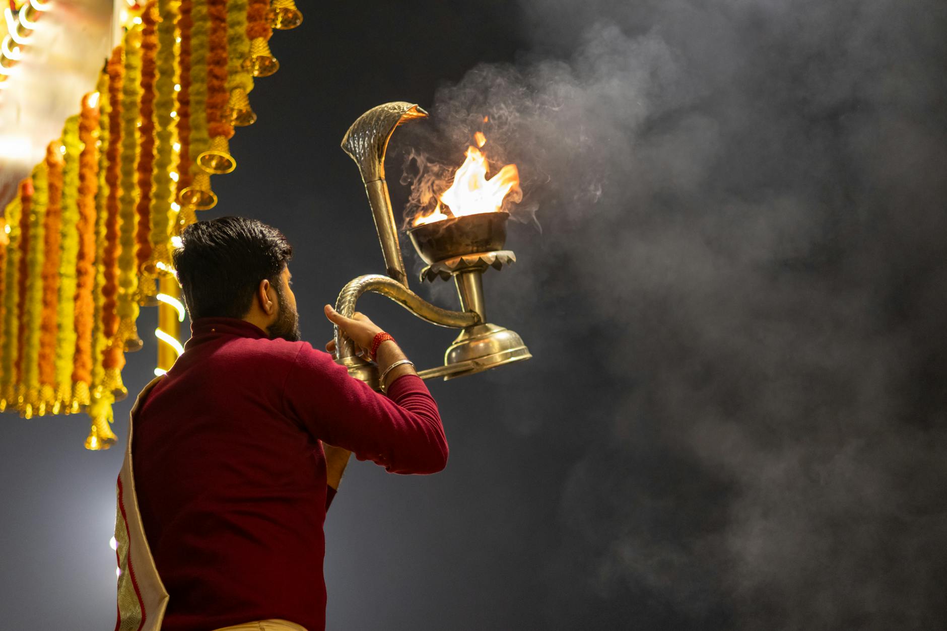 A priest performs the traditional Ganga Aarti ceremony at night in Varanasi, India.
