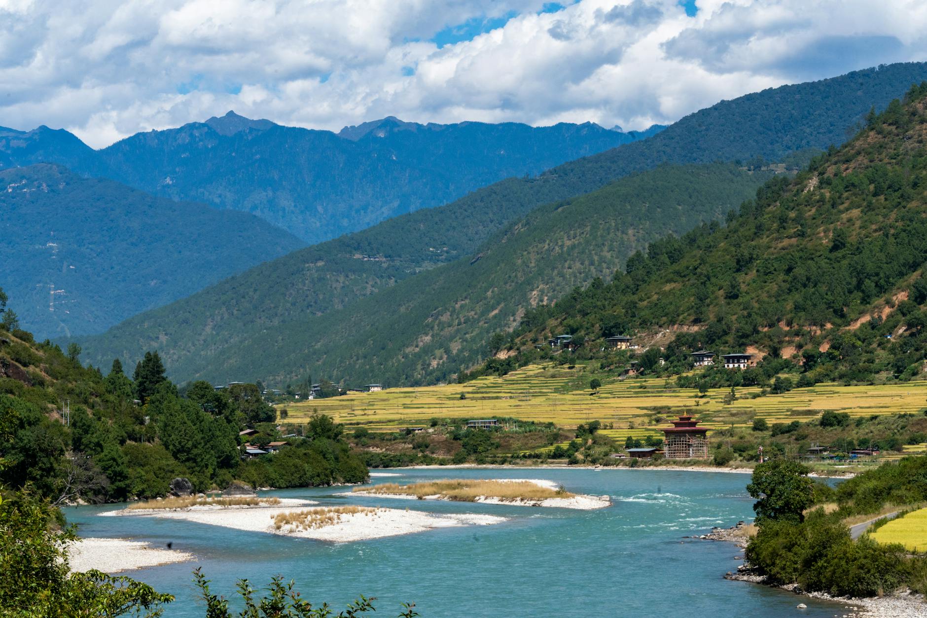 Picturesque landscape of the Punakha valley in Bhutan with lush greenery and mountains.