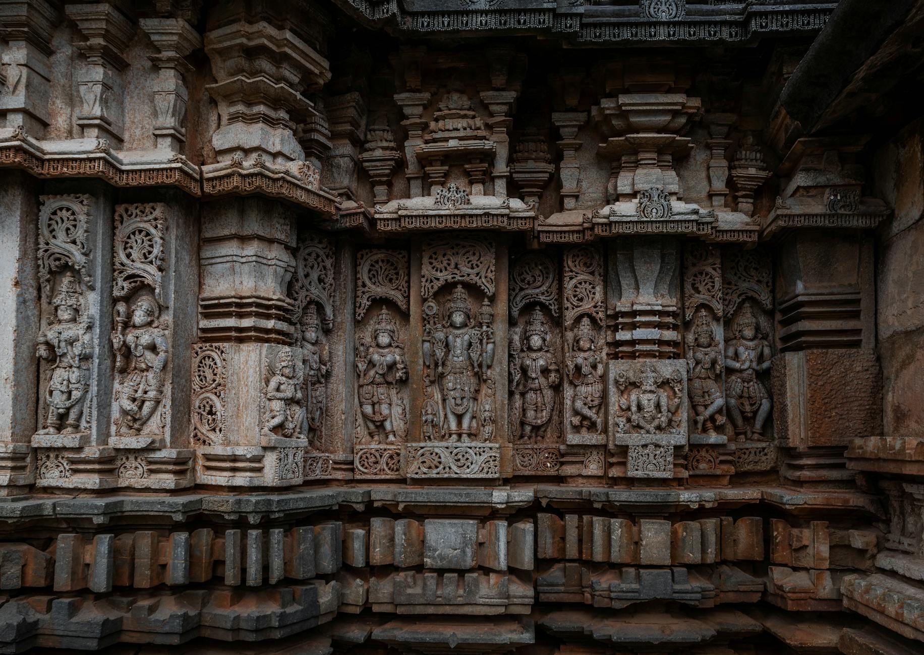 Detailed stone carvings on the wall of Belavadi Temple in Karnataka, India, showcasing ancient craftsmanship.